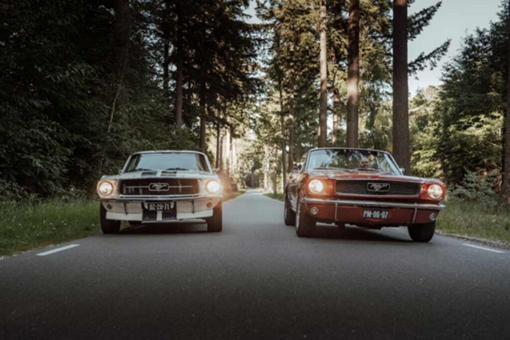 Classic muscle car and modern performance sports car side by side on a road. 🚗🏁