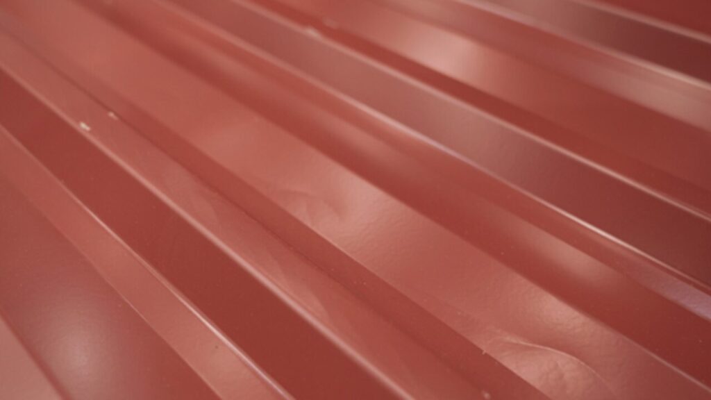 Modern home with durable metal roof installation at sunset.