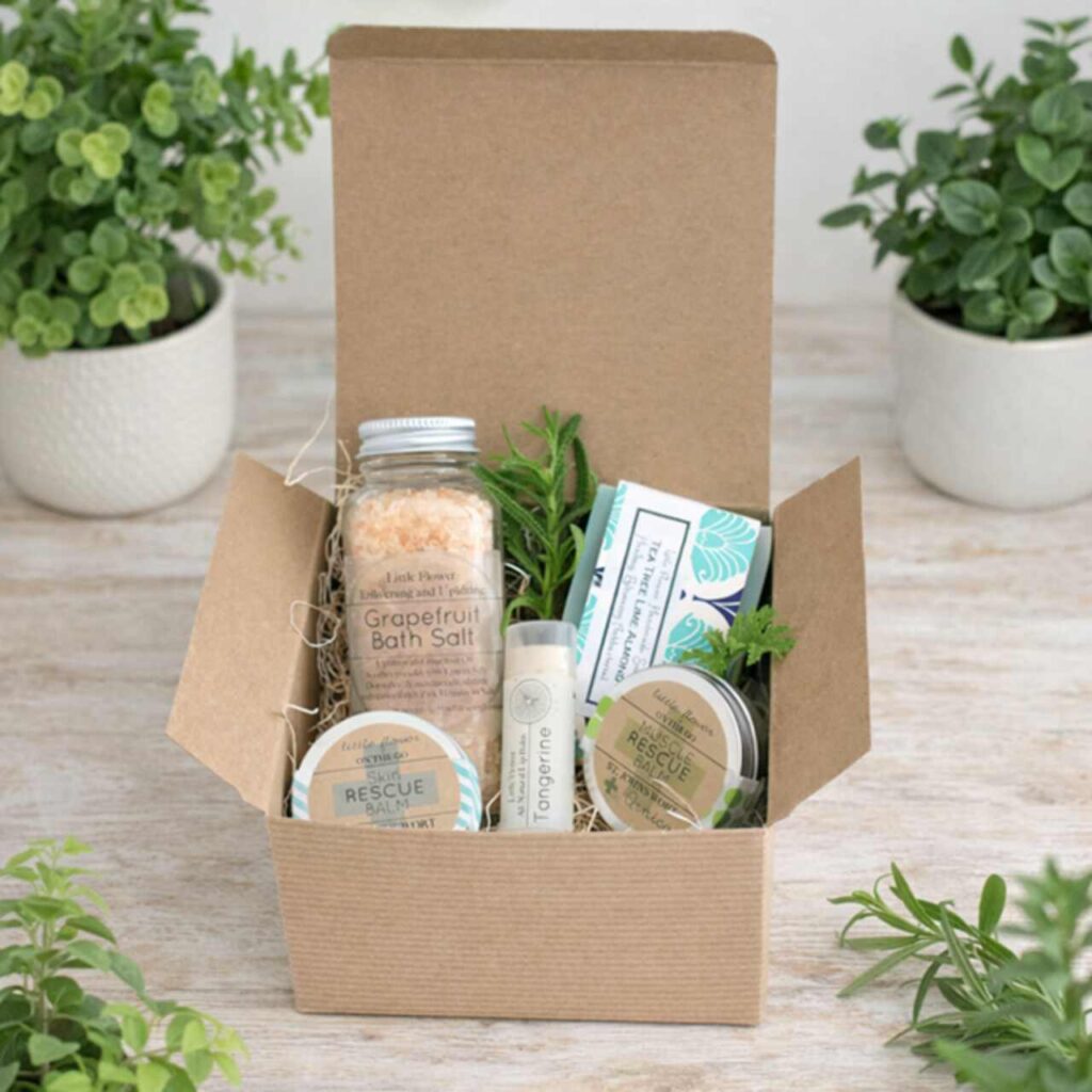 Woman enjoying spa massage with candles and gift boxes for Women’s Day spa gift ideas.